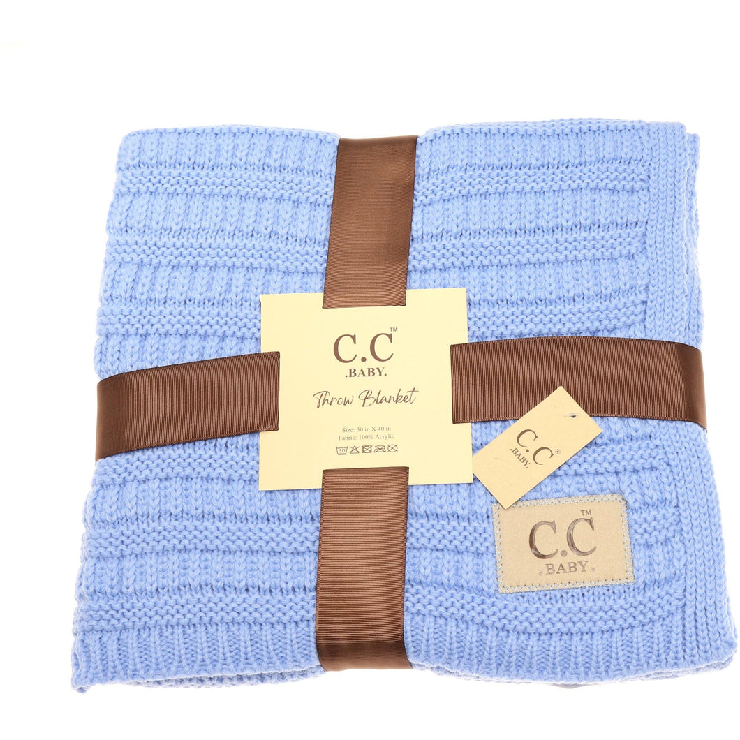 Blue baby blanket with brown ribbons and C.C Baby labels on a white background