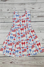 Load image into Gallery viewer, Dress with American flag and bow pattern on a wooden surface