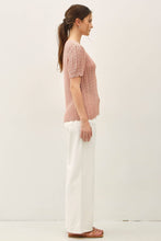 Load image into Gallery viewer, Woman wearing a pink knitted top and white pants on a white background