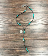 Load image into Gallery viewer, Necklace with turquoise beads on a wooden surface