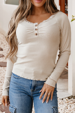 Load image into Gallery viewer, Woman wearing a beige ribbed long-sleeve top and blue jeans.