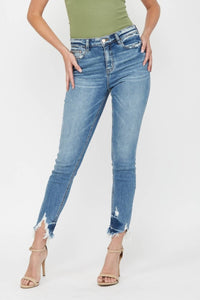 Blue jeans worn by a person on a white background