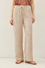 Load image into Gallery viewer, Person wearing beige striped pants with a plain background