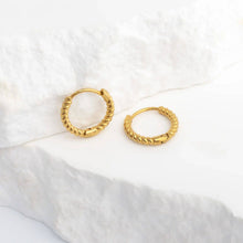 Load image into Gallery viewer, Gold hoop earrings on a white fabric background