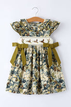 Load image into Gallery viewer, Floral dress with green ribbons on a hanger against a white background
