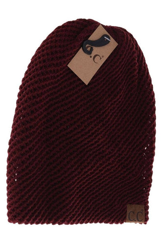 Maroon knitted beanie with a brand tag on a white background