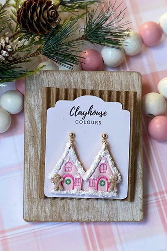 Decorative earrings on a 'Clayhouse Colours' branded card with Christmas-themed background