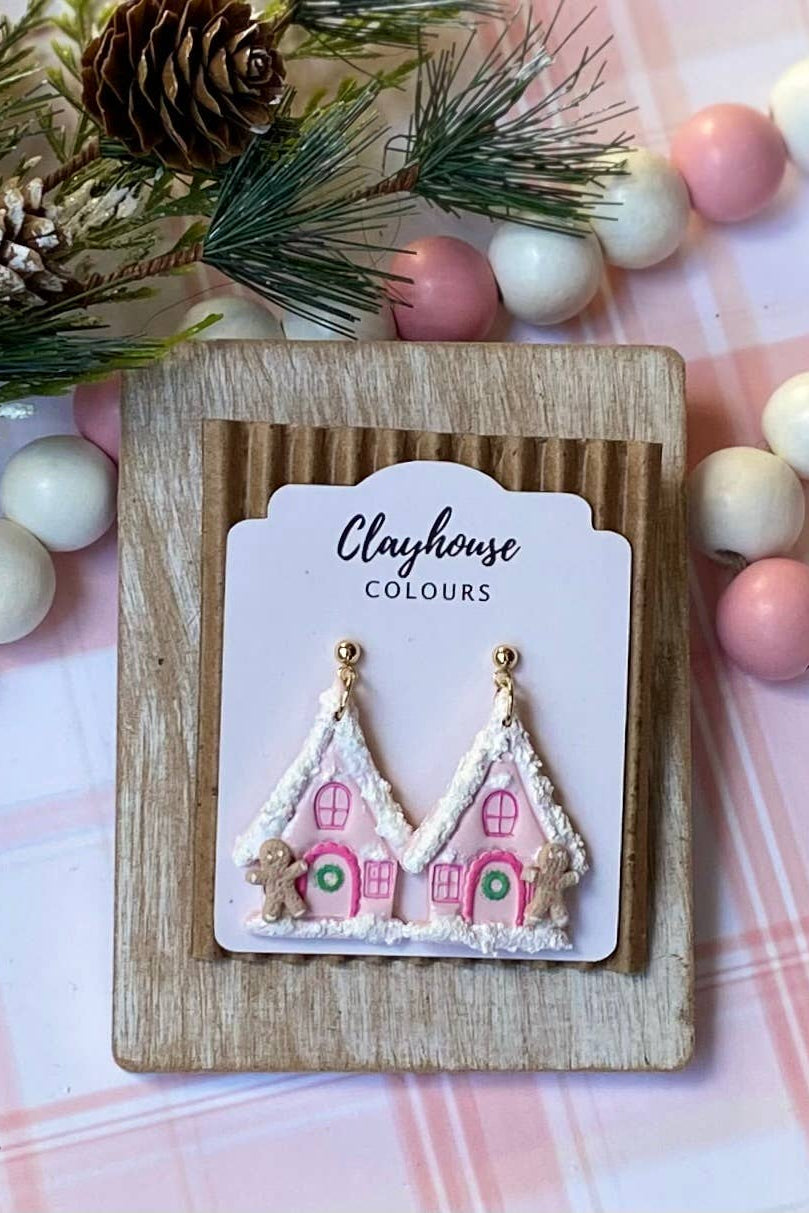 Decorative earrings on a 'Clayhouse Colours' branded card with Christmas-themed background