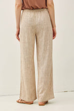 Load image into Gallery viewer, Person wearing beige pleated pants on a white background