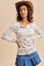 Load image into Gallery viewer, Woman wearing a floral long-sleeve top and denim skirt with a brown hat on a beige background