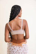 Load image into Gallery viewer, Woman wearing a beige lace bralette with a floral skirt on a white background