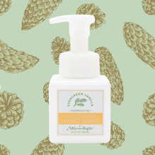 Load image into Gallery viewer, Hand soap bottle with a label on a green background with pine cone pattern