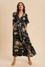 Load image into Gallery viewer, Woman wearing a floral dress against a beige background
