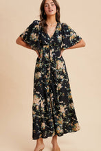 Load image into Gallery viewer, Woman wearing a floral dress against a beige background