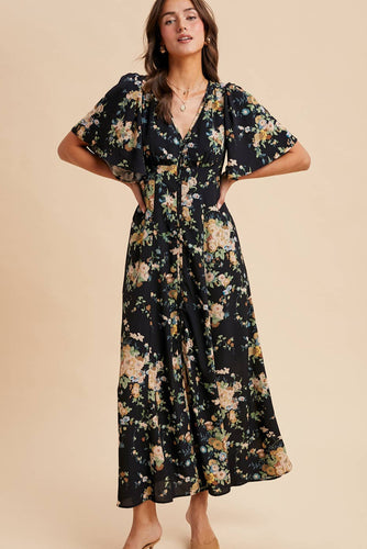 Woman wearing a floral dress against a beige background