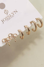 Load image into Gallery viewer, Gold hoop earrings on a Josslyn Company card with a beige background