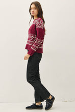 Load image into Gallery viewer, Woman wearing a red patterned sweater and black pants on a white background