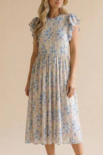 Load image into Gallery viewer, Woman wearing a floral dress against a beige background