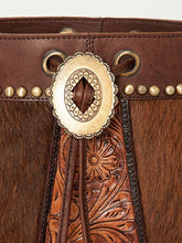 Load image into Gallery viewer, Close-up of a brown leather boot with decorative gold buckle and floral patterns.