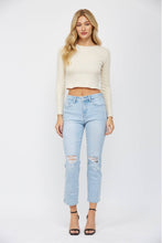 Load image into Gallery viewer, Woman wearing a cream long-sleeve top and light blue jeans on a white background