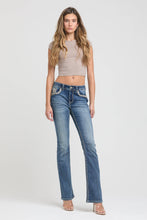 Load image into Gallery viewer, Woman wearing blue jeans with decorative elements on a white background