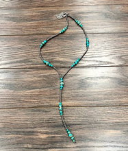 Load image into Gallery viewer, Necklace with turquoise beads on a wooden surface