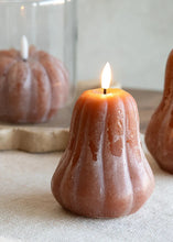 Load image into Gallery viewer, Three ribbed pumpkin-shaped candles in a warm brown color, with the center candle lit and displayed on a neutral fabric surface.