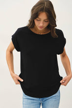 Load image into Gallery viewer, Woman wearing a black t-shirt and blue jeans against a white background