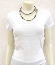 Load image into Gallery viewer, White t-shirt on a mannequin with a necklace against a plain background
