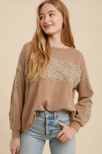 Load image into Gallery viewer, Woman wearing a brown sweater with lace details on a beige background