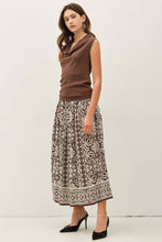 Load image into Gallery viewer, Woman wearing a brown top and patterned skirt on a white background