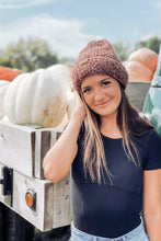 Load image into Gallery viewer, Woman in a beanie standing next to a truck with pumpkins at a pumpkin patch.