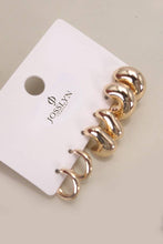 Load image into Gallery viewer, Gold spiral earrings on a Josievn branded card