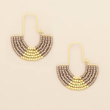 Load image into Gallery viewer, Pair of beaded earrings with gold and gray design on a beige background