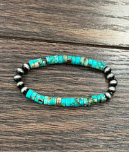 Load image into Gallery viewer, Turquoise beaded bracelet with black beads on a wooden surface