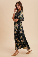 Load image into Gallery viewer, Woman wearing a floral dress on a beige background