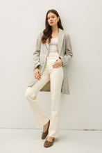 Load image into Gallery viewer, Woman wearing a light gray blazer over a white top and pants on a white background