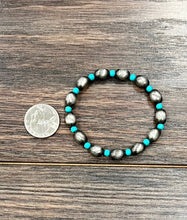 Load image into Gallery viewer, Bracelet with turquoise beads on a wooden surface next to a coin for size reference