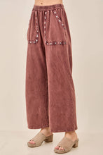 Load image into Gallery viewer, Mauve wide-leg pants with embellishments on a beige background
