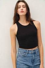 Load image into Gallery viewer, Woman wearing a black tank top and blue jeans against a plain background