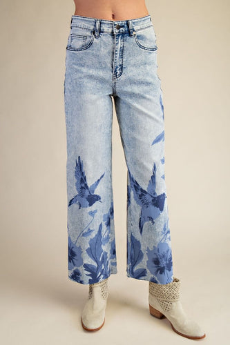 CLOSE UP OF WOMAN WEARING BLUE JEANS WITH BIRD DESIGN