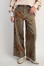 Load image into Gallery viewer, Woman wearing olive trouser with flower pant against white background wall