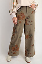 Load image into Gallery viewer, Woman wearing olive trouser with flower pant against white background wall
