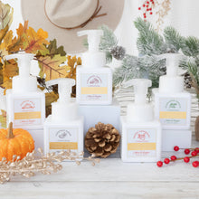 Load image into Gallery viewer, Hand soap bottles with pump dispensers on a decorative background with pumpkins, pinecones, and berries.