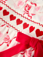 Load image into Gallery viewer, Close-up of red heart patterned ribbon with a red bow on a white background