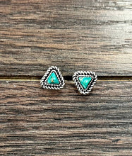 Load image into Gallery viewer, Pair of silver triangle earrings with turquoise stones on a wooden surface