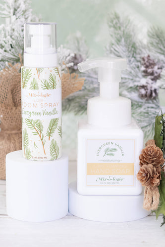 Two bottles of Aller-Magic products on a white surface with a Christmas-themed background.