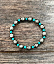 Load image into Gallery viewer, Bracelet with alternating silver and turquoise beads on a wooden surface