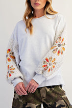 Load image into Gallery viewer, woman wearing grey colored sweatshirt with quilted sleeves with flower patches