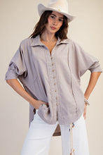 Load image into Gallery viewer, Woman wearing a light purple button-up shirt, white pants, and a white cowboy hat on a beige background